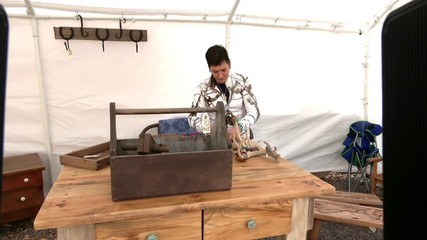 Craft Vendor in Outdoor Market - Furniture and jewelry maker setting up for the day in Silver City, NM.