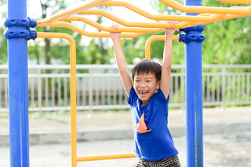 Young boy play with yellow bar