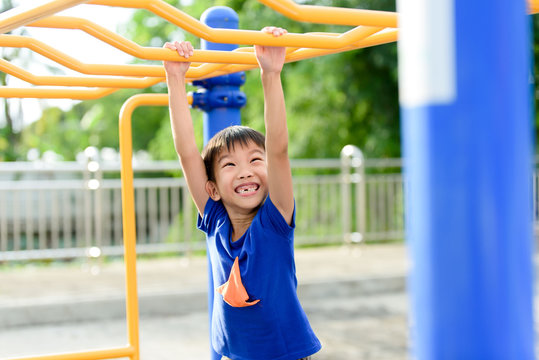 Young boy play with yellow bar