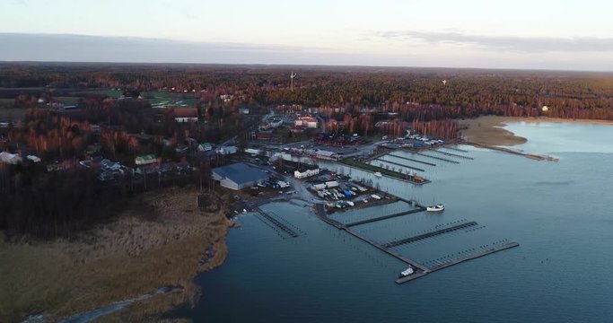 Cinema 4k aerial flight towards Inkoo town, at a late evening sunset, in the finnish archipelago, in Finland