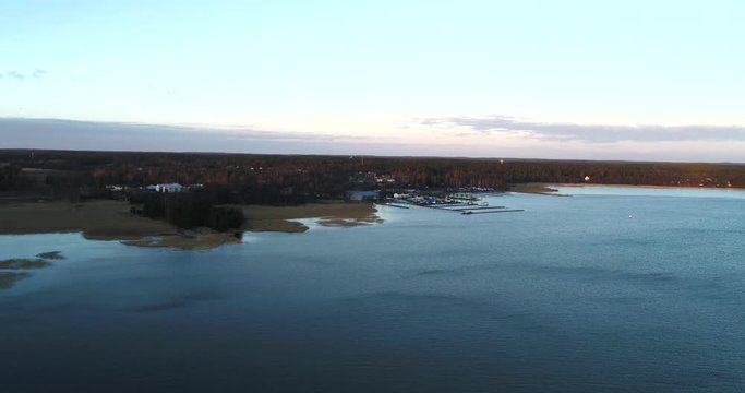 Cinema 4k aerial flight towards Inkoo town, at a sunset, on a evening, in the finnish archipelago, in Finland