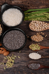 Cereal grains , seeds, beans on wooden background