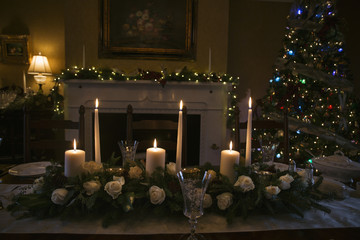 Christmas table floral arrangement with candles and Christmas tree