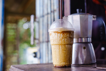 Coffee time, coffee frappucino on woodtable with old Moka pot.