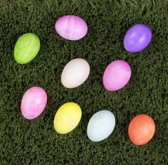 Colorful eggs for Easter holiday on green grass