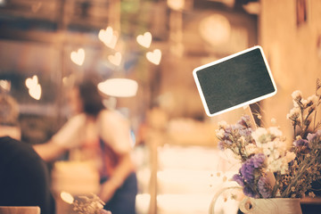 Sign in the restaurant in soft focus with warm fall color and heart bokeh with vintage filter.