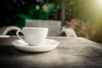 Cup of coffee on table in the garden
