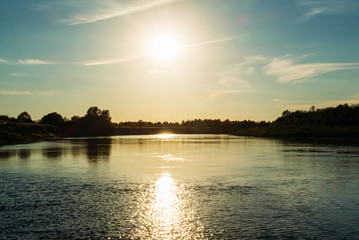 Naklejka premium Summer river landscape during the sunset