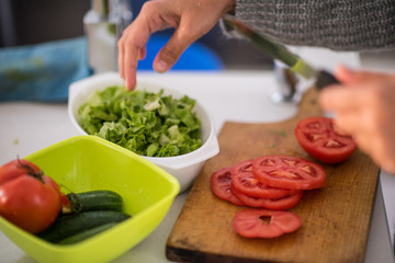 Making salad for lunch in modern kitchen