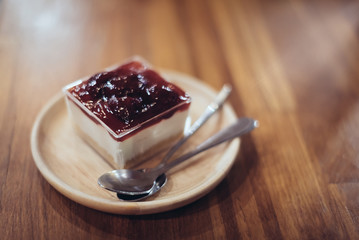 Abstract of love : Strawberry Cheese Cake on the wooden table in soft focus with film filter (add noise and grain) in warm fall color.