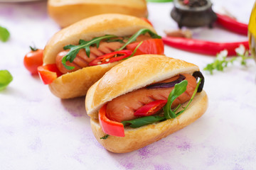 Hot dog with sausage and vegetables in the Greek style.