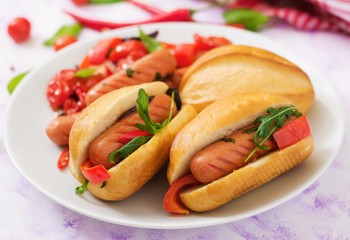 Hot dog with sausage and vegetables in the Greek style.
