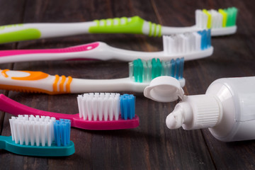 new manual toothbrushes on the dark wooden background