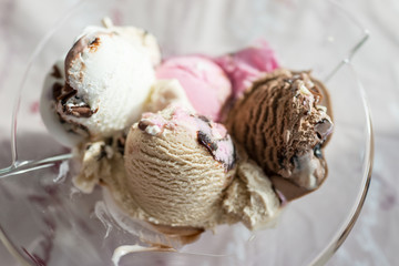 Ice cream scoops on wooden table, close-up