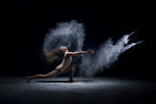 Contemporary dancer performing  in cloud of powder