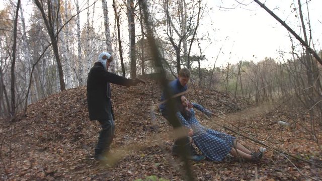 The Thug Captured The Guy And The Girl In The Forest.

The Man With The Gun Forces A Young Man To Drag The Girl. Slow Motion.