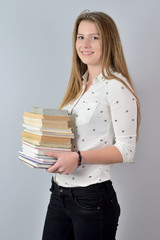 Student with lots of books. - obrazy, fototapety, plakaty