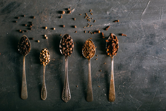 Spices on spoons shoot from above