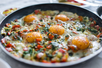 In the course of making breakfast with fresh eggs and vegetables
