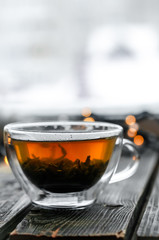 Transparent Cup of tea on wooden background