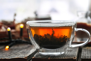 Transparent Cup of tea on wooden background