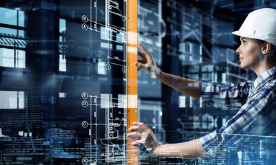 Builder woman taking measures . Mixed media