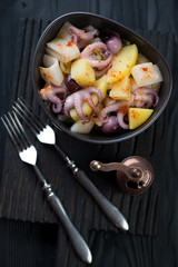 Salad with boiled potato, pickled baby octopuses and calamari