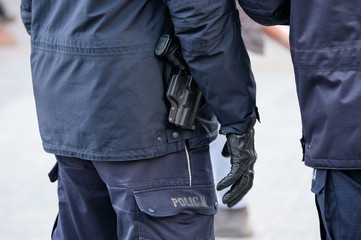 Armed with a pistol police man ready to use weapons