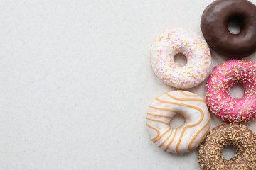 Donuts in color glaze on a light background.