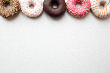 Donuts in color glaze on a light background.