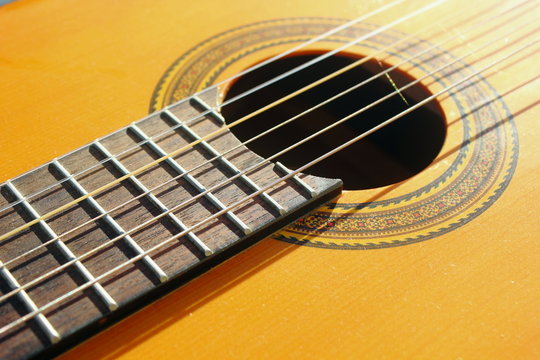 closeup guitar strings and fret work