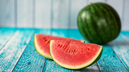 Watermelon slice popsicles on a blue rustic wood background. Selective focus