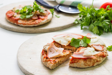 Pita pizza with ham, cheese and vegetables