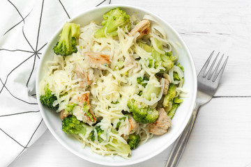 Rice noodles with broccoli and chicken on top. Top view.