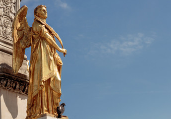 Fototapeta premium Gold Angel sculpture, fountain in front of cathedral in Zagreb, Croatia