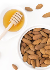 Almonds and honey isolated on white background overhead shot