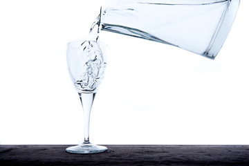Filling glass with water from jug