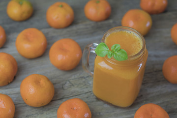 Freshly squeezed healthy citrus tangerine juice in jar and ripe