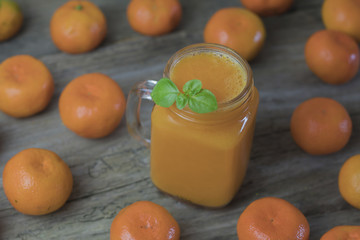 Freshly squeezed healthy citrus tangerine juice in jar and ripe