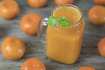 Freshly squeezed healthy citrus tangerine juice in jar and ripe