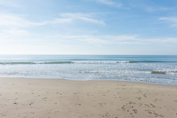 waves, sea and sun reflecting from the beach - background
