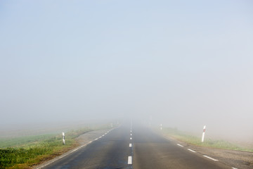 Empty long highway with fog