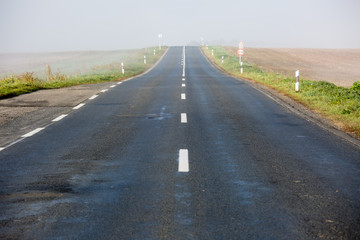 Empty long highway with fog