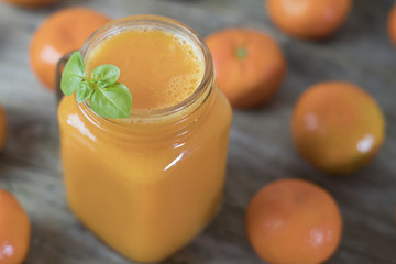 Freshly squeezed healthy citrus tangerine juice in jar and ripe