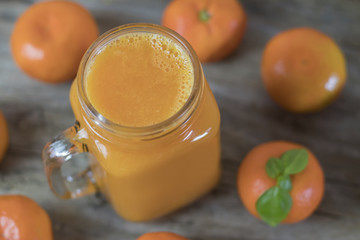 Freshly squeezed healthy citrus tangerine juice in jar and ripe