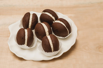 macaroon small round chocolate cake lies in a plate