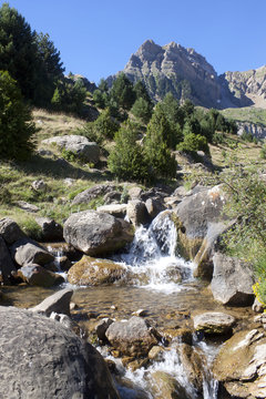 stream between rocks in the middle of the mountains in Pyrenees, Spain