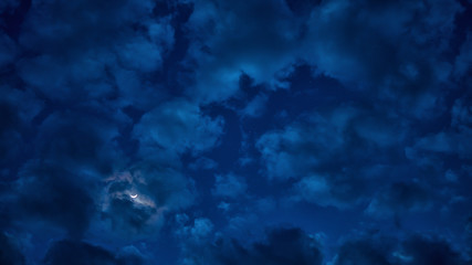 Cloudy and moon in the night sky.