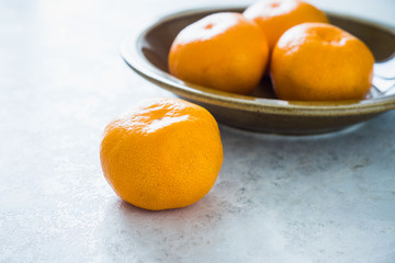 Tangerines on white table. Shallow depth of field.