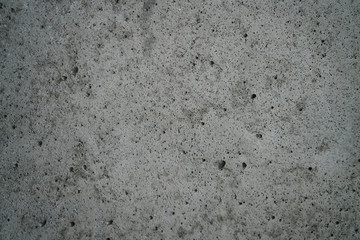 rough grey grungy concrete background, focus in the middle of frame